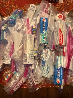 11 sets of toothbrushes/toothpaste/floss PLUS 2 x Value packs of tooth brushes